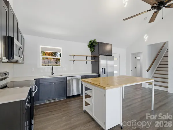 a kitchen with a sink and a refrigerator