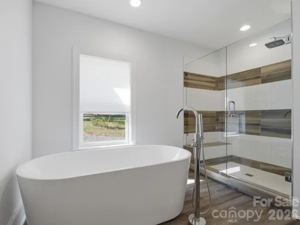 a bedroom with furniture and a flat screen tv