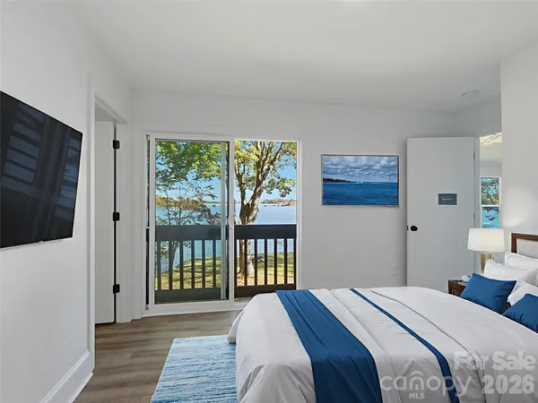 a bedroom with a bed and a large window