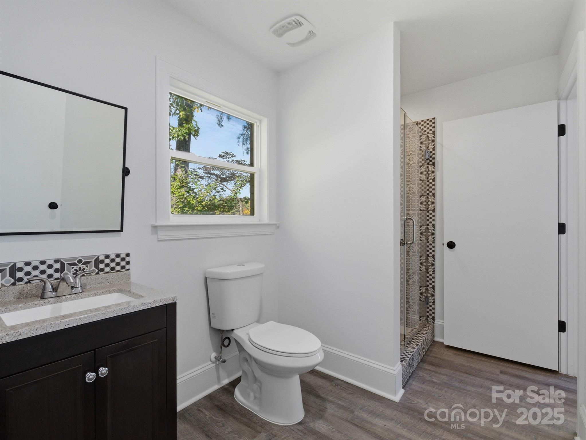 9115 Clement Circle Terrell, NC 28682 - Photo 34 of 48 a bathroom with a toilet sink and mirror