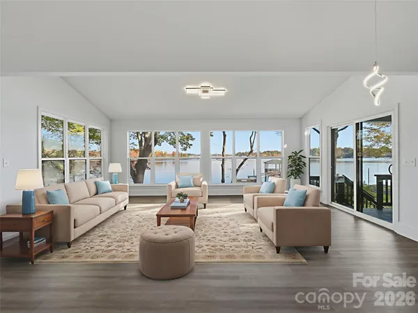 a view of a livingroom with furniture a ceiling fan and wooden floor