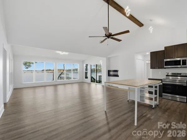 a kitchen with a refrigerator cabinets and wooden floor