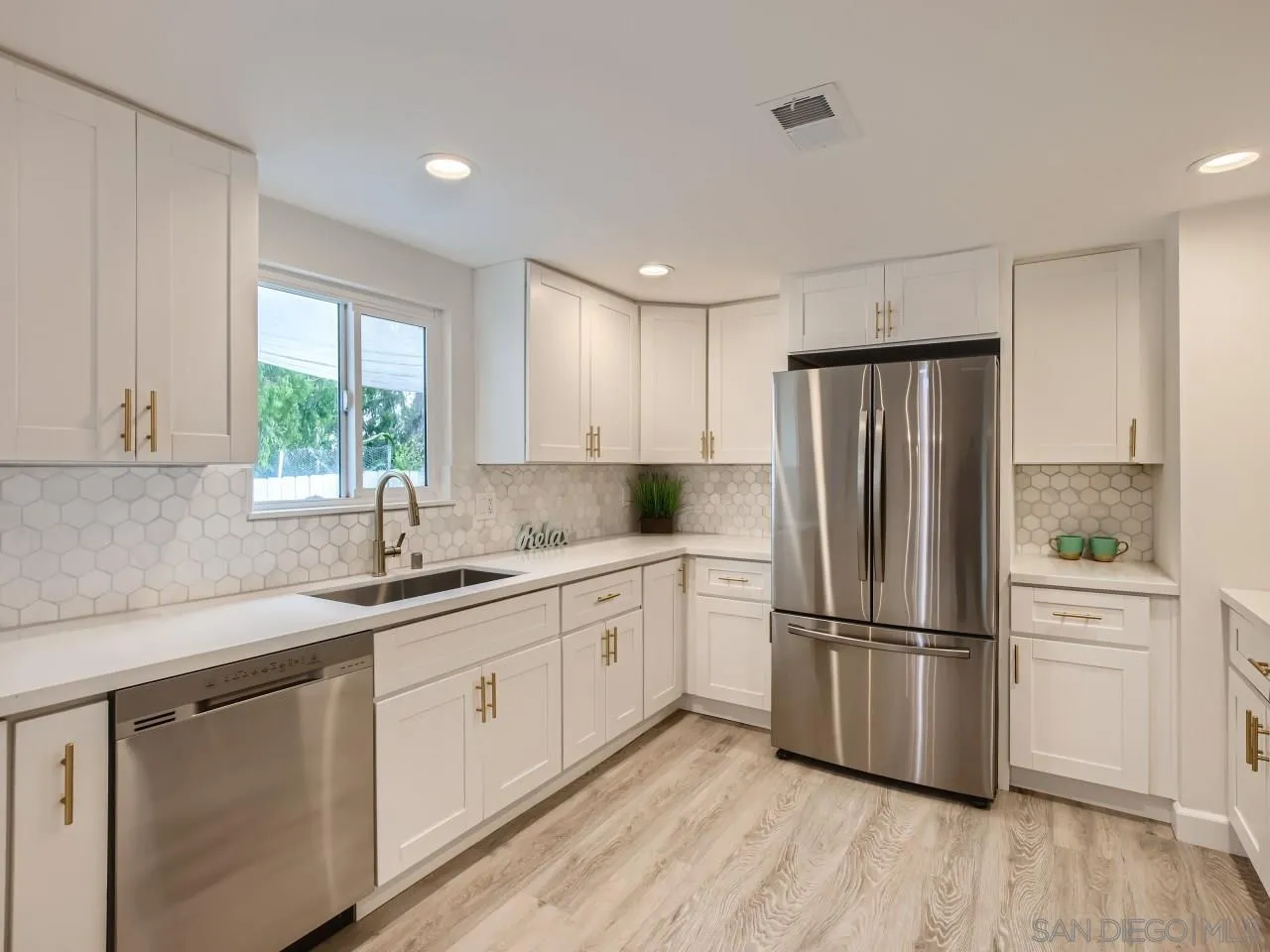 2902 Thunder Drive Oceanside, CA 92056 - Photo 11 of 30 a kitchen with appliances cabinets a sink and a window
