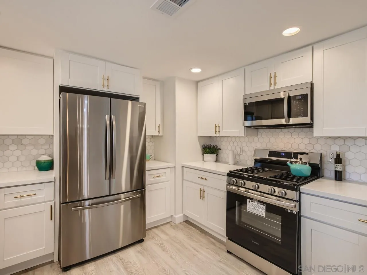 2902 Thunder Drive Oceanside, CA 92056 - Photo 12 of 30 a kitchen with a refrigerator stove and microwave