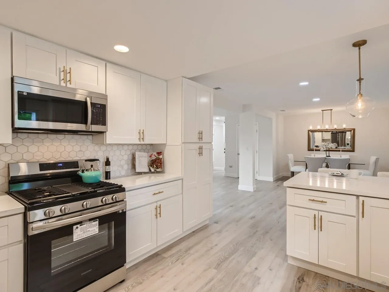 2902 Thunder Drive Oceanside, CA 92056 - Photo 13 of 30 a kitchen with stainless steel appliances white cabinets and a stove top oven