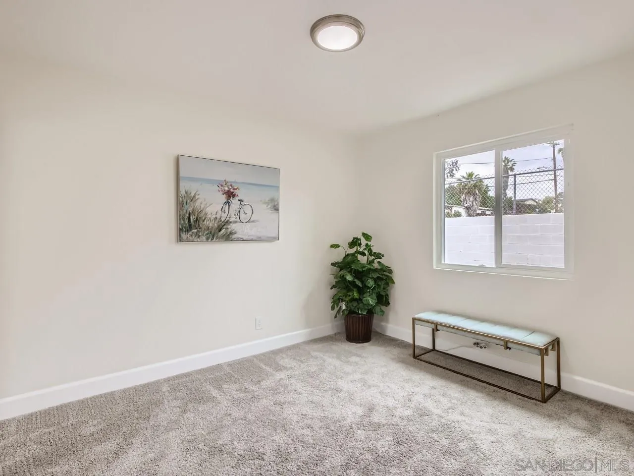 2902 Thunder Drive Oceanside, CA 92056 - Photo 23 of 30 an empty room with windows and flowers