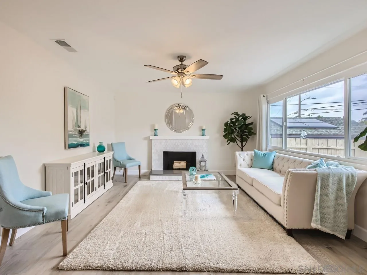 2902 Thunder Drive Oceanside, CA 92056 - Photo 8 of 30 a living room with furniture a fireplace and a large window