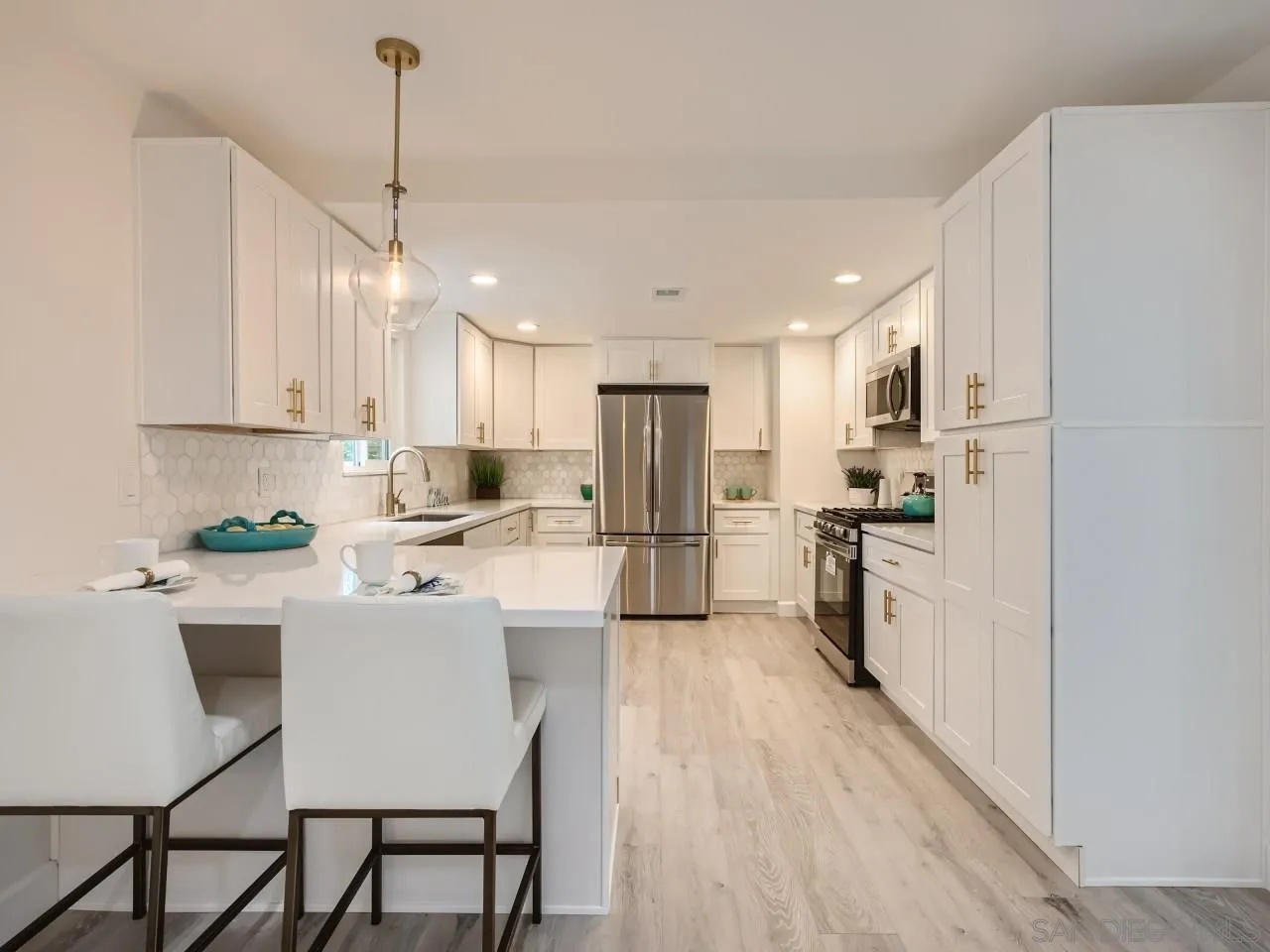 2902 Thunder Drive Oceanside, CA 92056 - Photo 10 of 30 a kitchen with white cabinets and stainless steel appliances