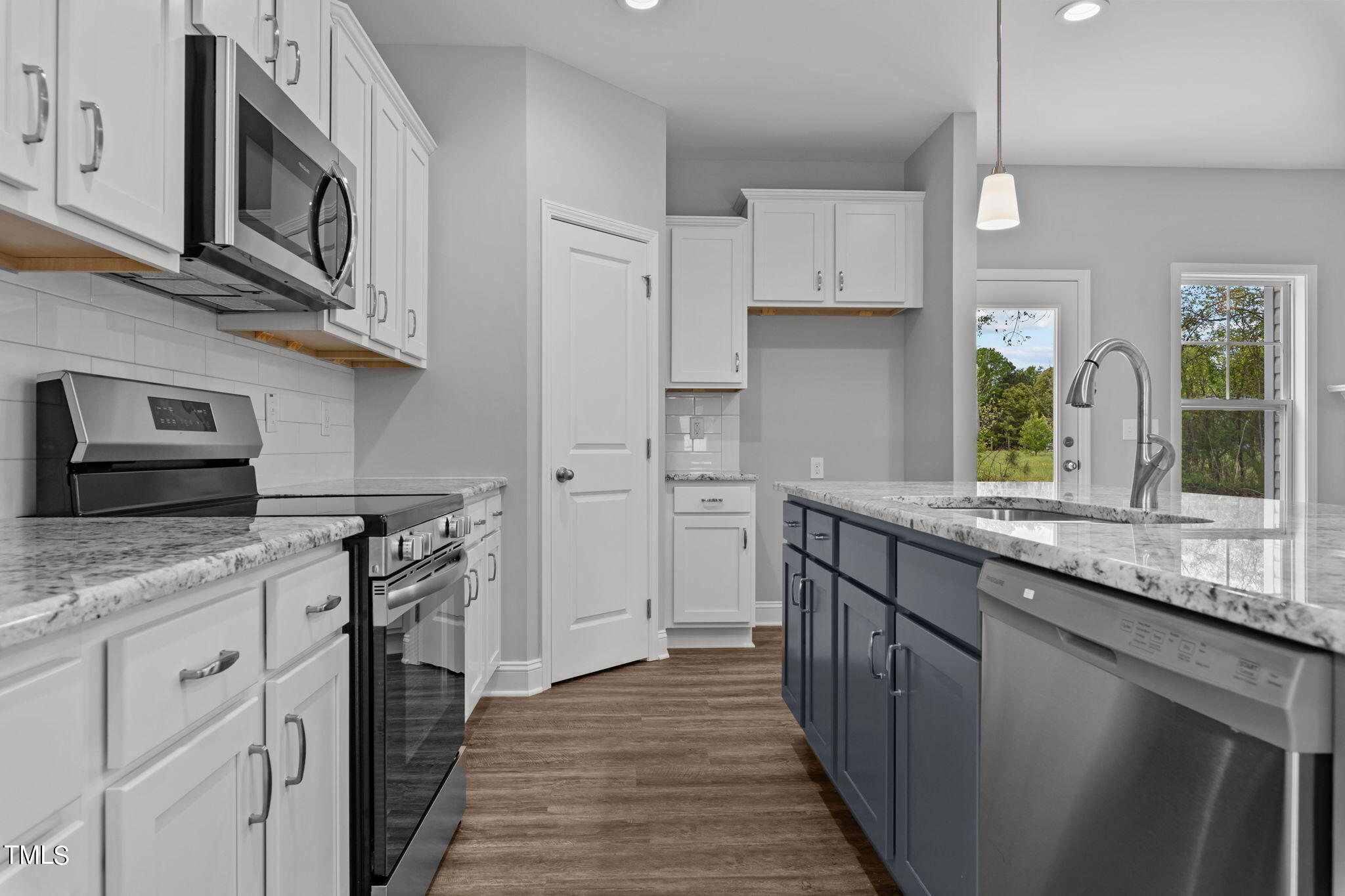 161 Regis Lane Coats, NC 27521 - Photo 12 of 38 a kitchen with stainless steel appliances granite countertop a stove and a sink