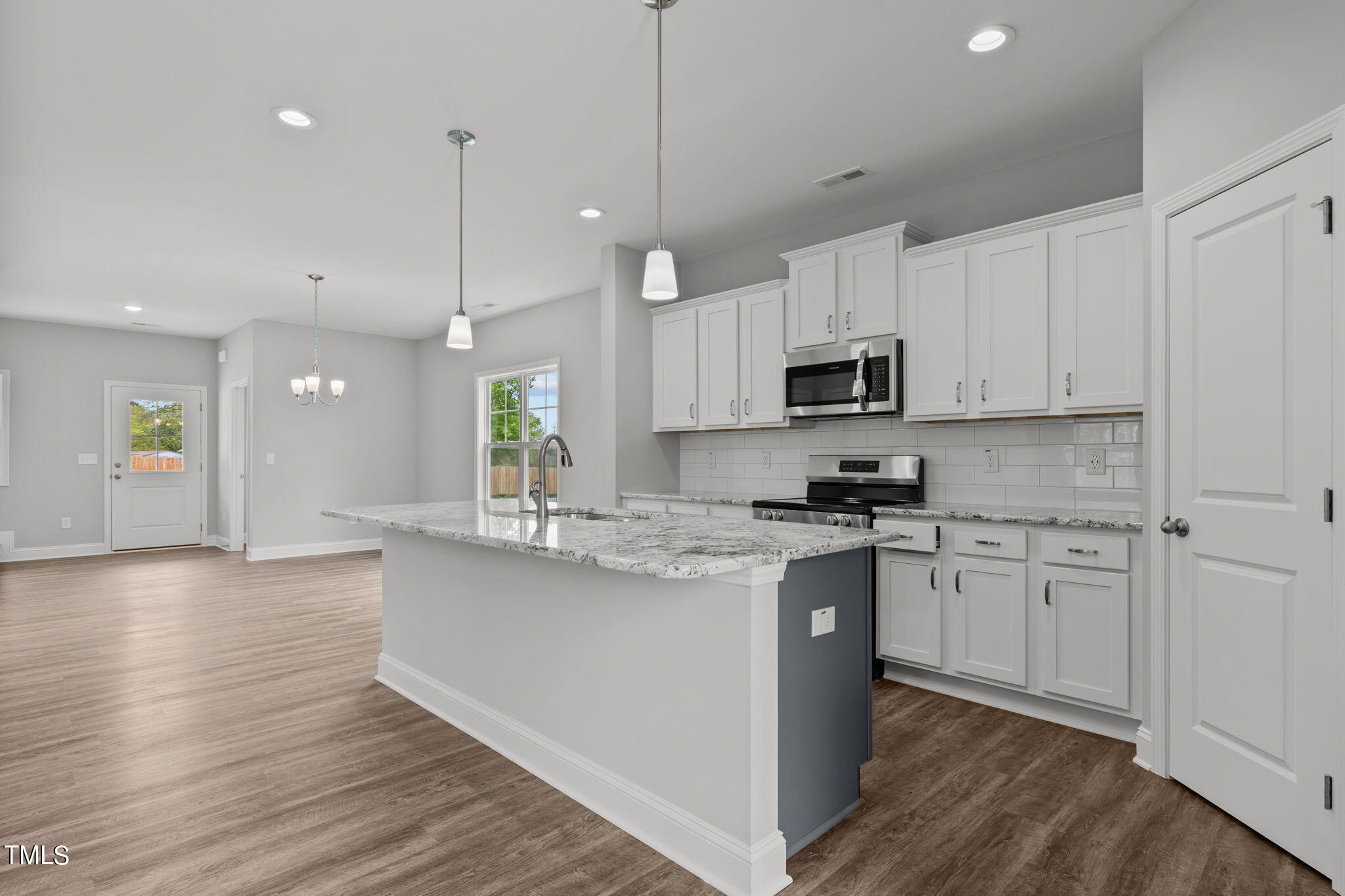 161 Regis Lane Coats, NC 27521 - Photo 13 of 38 a kitchen with stainless steel appliances granite countertop a stove a sink and a microwave