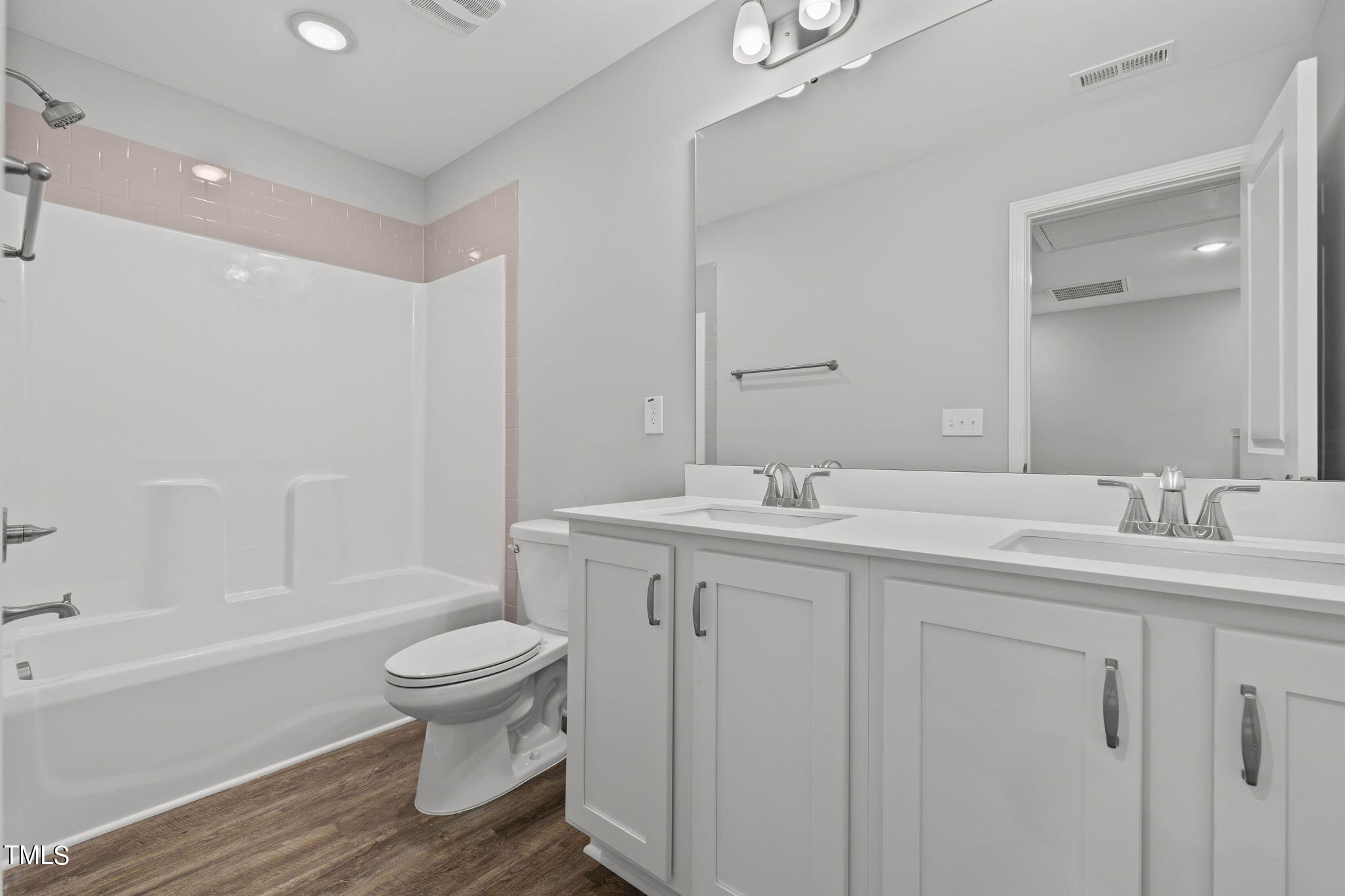 161 Regis Lane Coats, NC 27521 - Photo 20 of 38 a bathroom with a double vanity sink toilet and shower