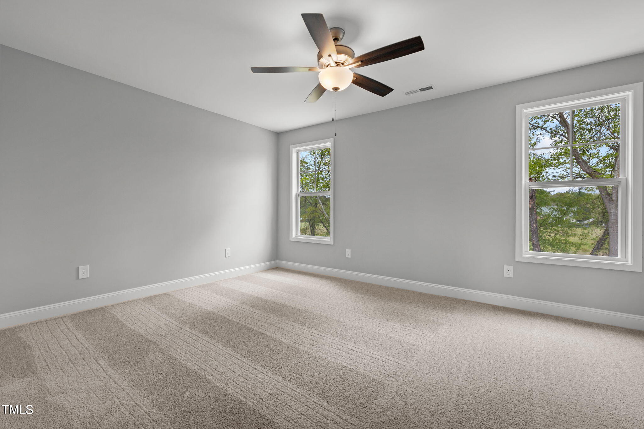 161 Regis Lane Coats, NC 27521 - Photo 24 of 38 an empty room with a window and a fan