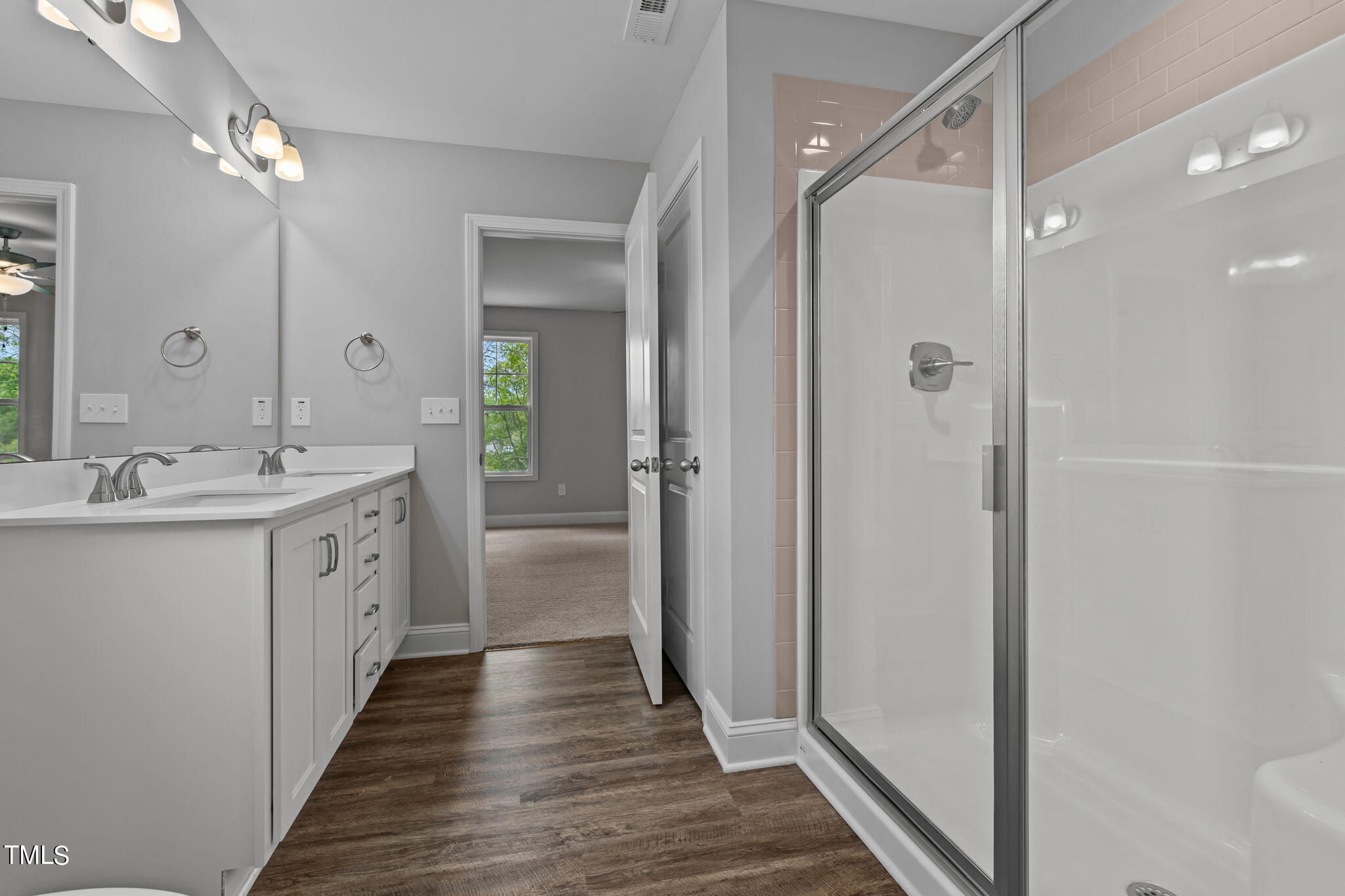 161 Regis Lane Coats, NC 27521 - Photo 29 of 38 a bathroom with a double vanity sink and a mirror