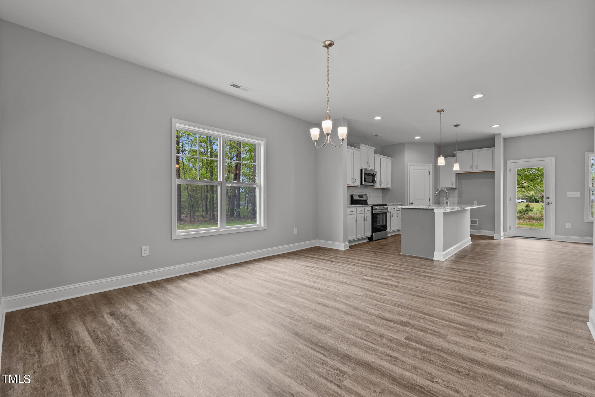 161 Regis Lane Coats, NC 27521 - Photo 6 of 38 a view of kitchen with kitchen island wooden floor and window