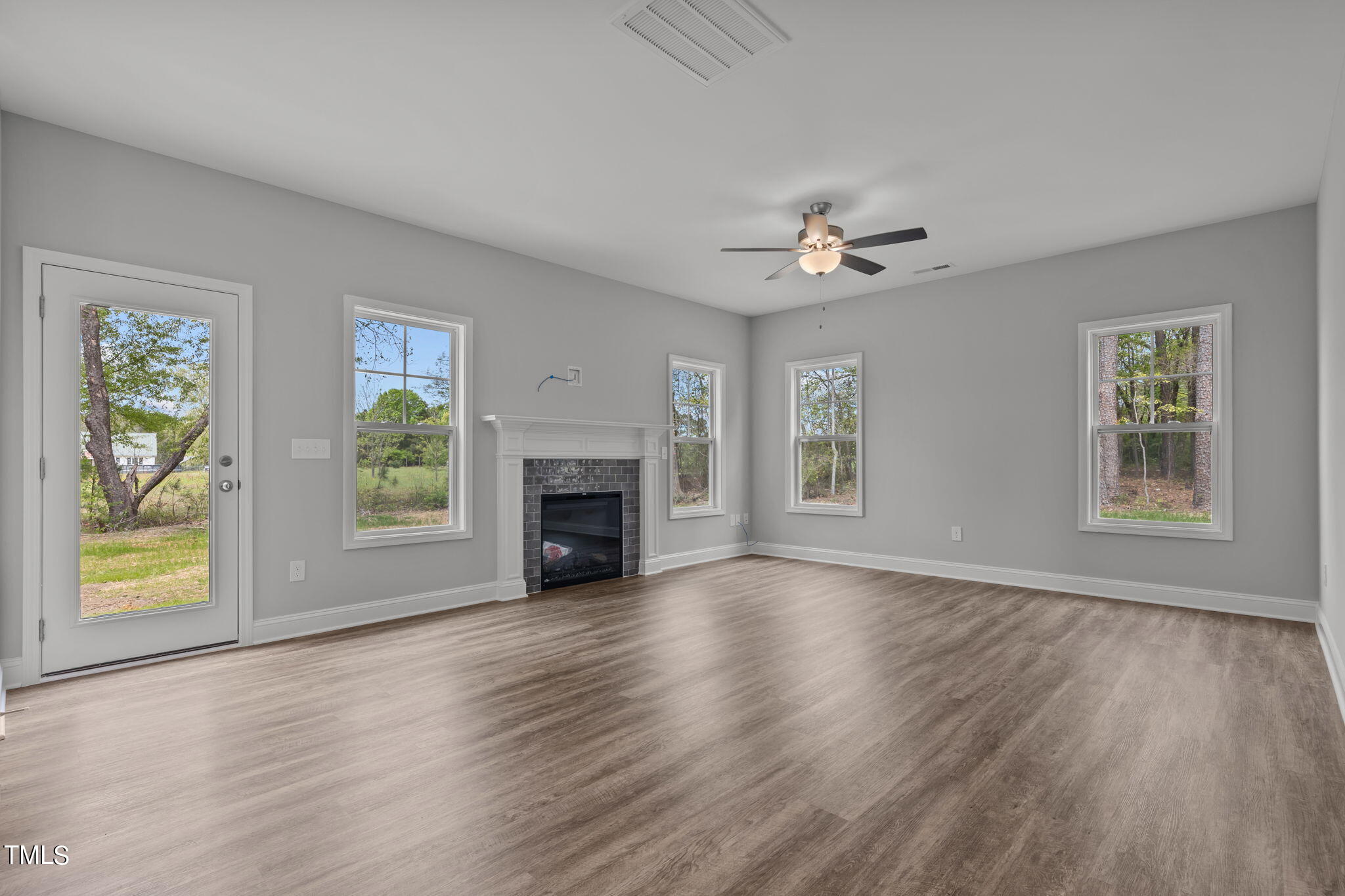 161 Regis Lane Coats, NC 27521 - Photo 8 of 38 a view of an empty room with window and wooden floor