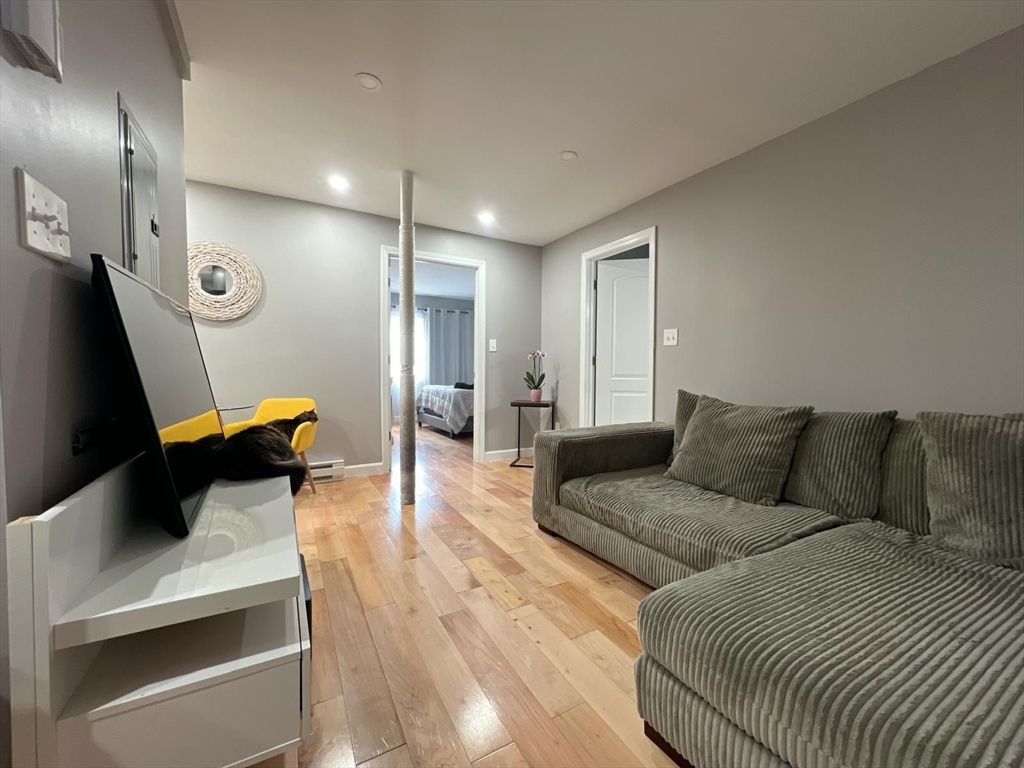 7 Weld Street, Unit 29 Framingham, MA 01702 - Photo 2 of 8 a living room with furniture and a wooden floor