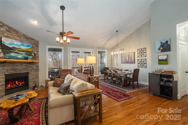 a living room with furniture a fireplace and a flat screen tv