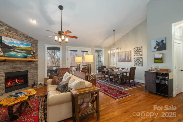 a living room with furniture a fireplace and a flat screen tv
