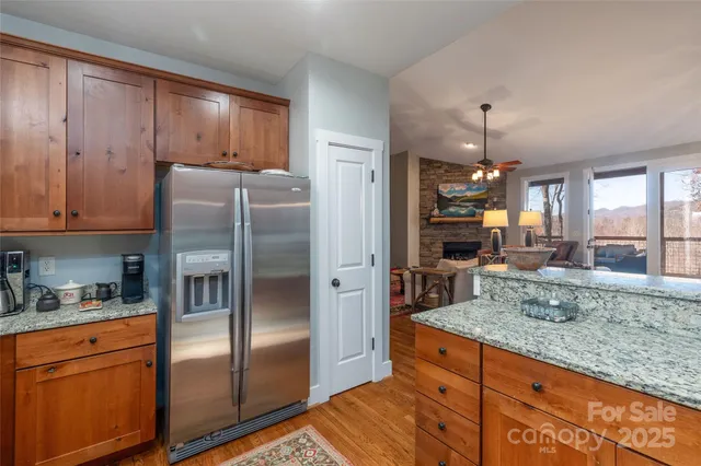 a kitchen with stainless steel appliances granite countertop a refrigerator and a sink
