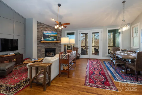 a living room with furniture a flat screen tv and a fireplace