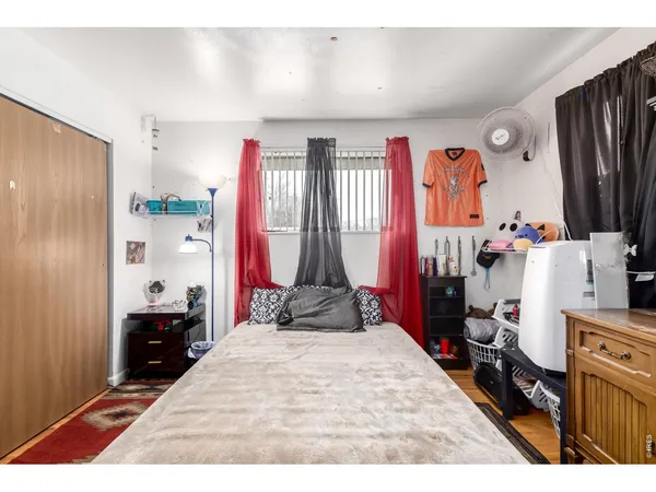 a room with a bed and a large window