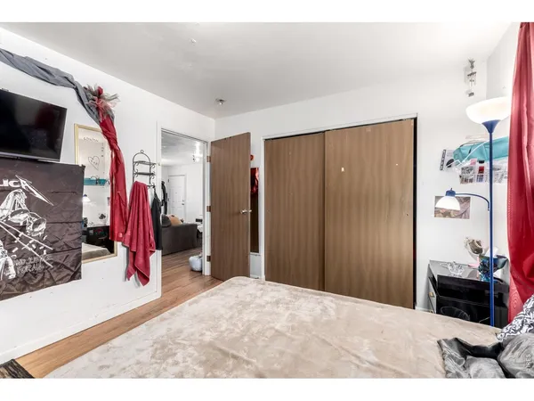 a bedroom with a bed and a television