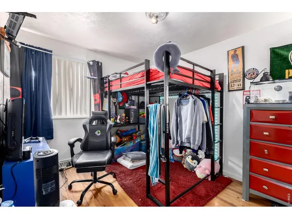a living room with furniture a flat screen tv and gym equipment