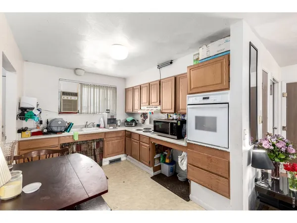 a kitchen with stainless steel appliances granite countertop a refrigerator sink and cabinets