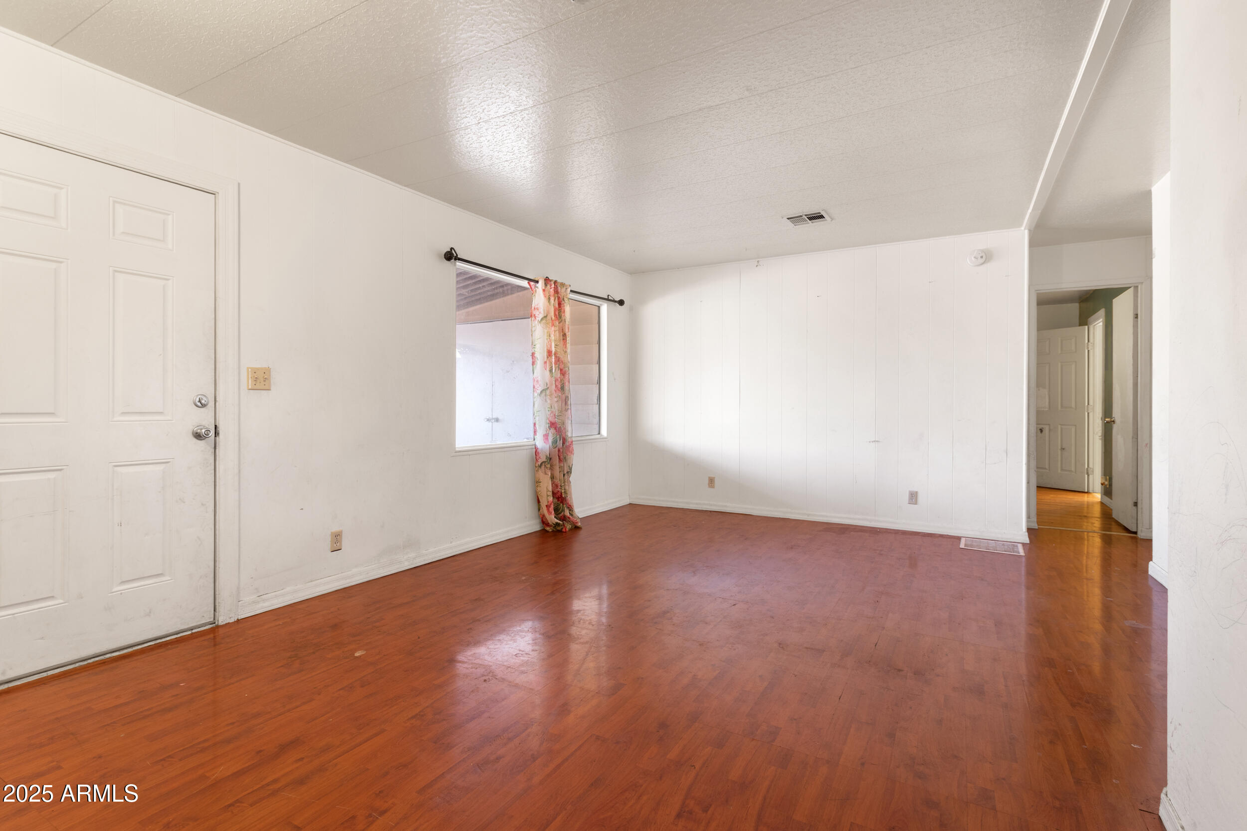 400 West Baseline Road, Unit 179 Tempe, AZ 85283 - Photo 14 of 50 an empty room with wooden floor and windows