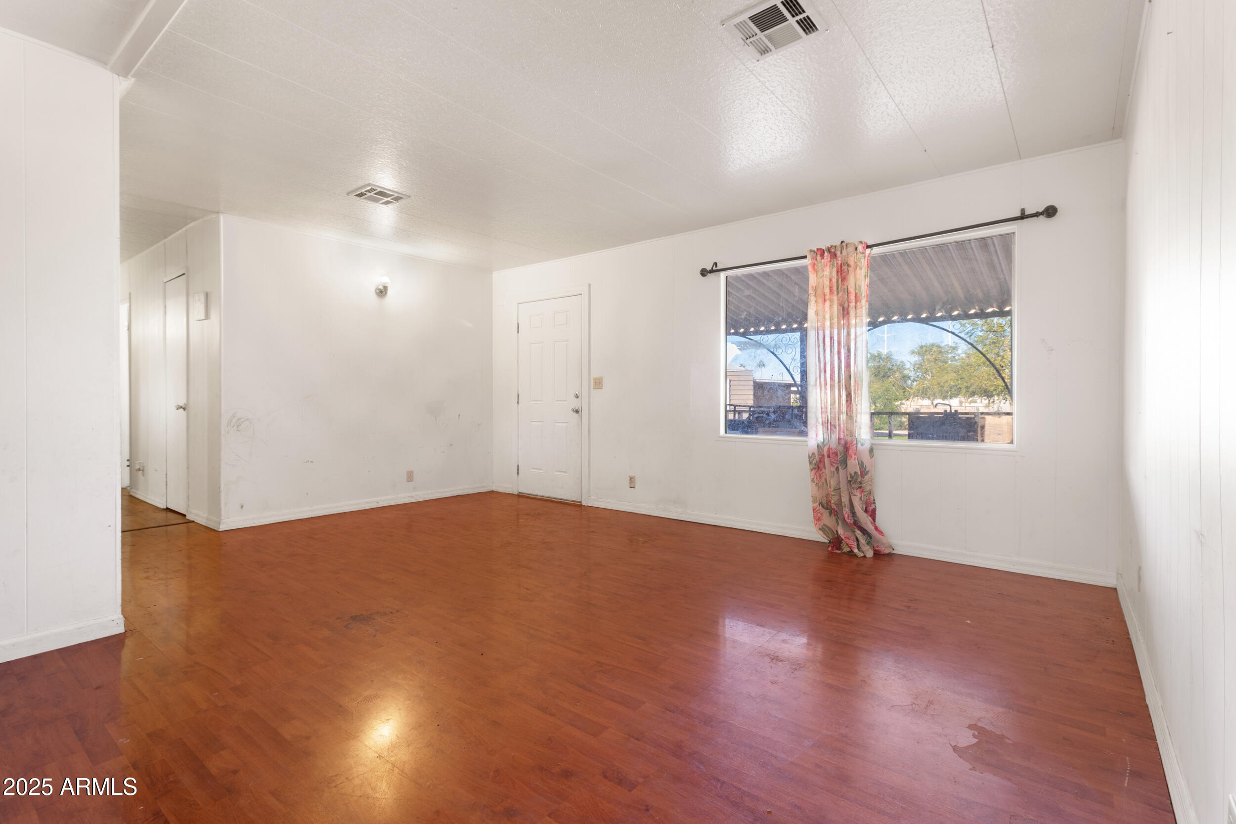 400 West Baseline Road, Unit 179 Tempe, AZ 85283 - Photo 17 of 50 an empty room with wooden floor and windows