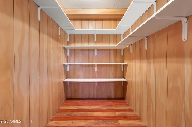 a view of wooden floor and windows in a room
