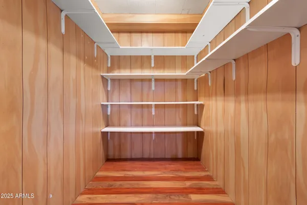 a view of wooden floor and windows in a room