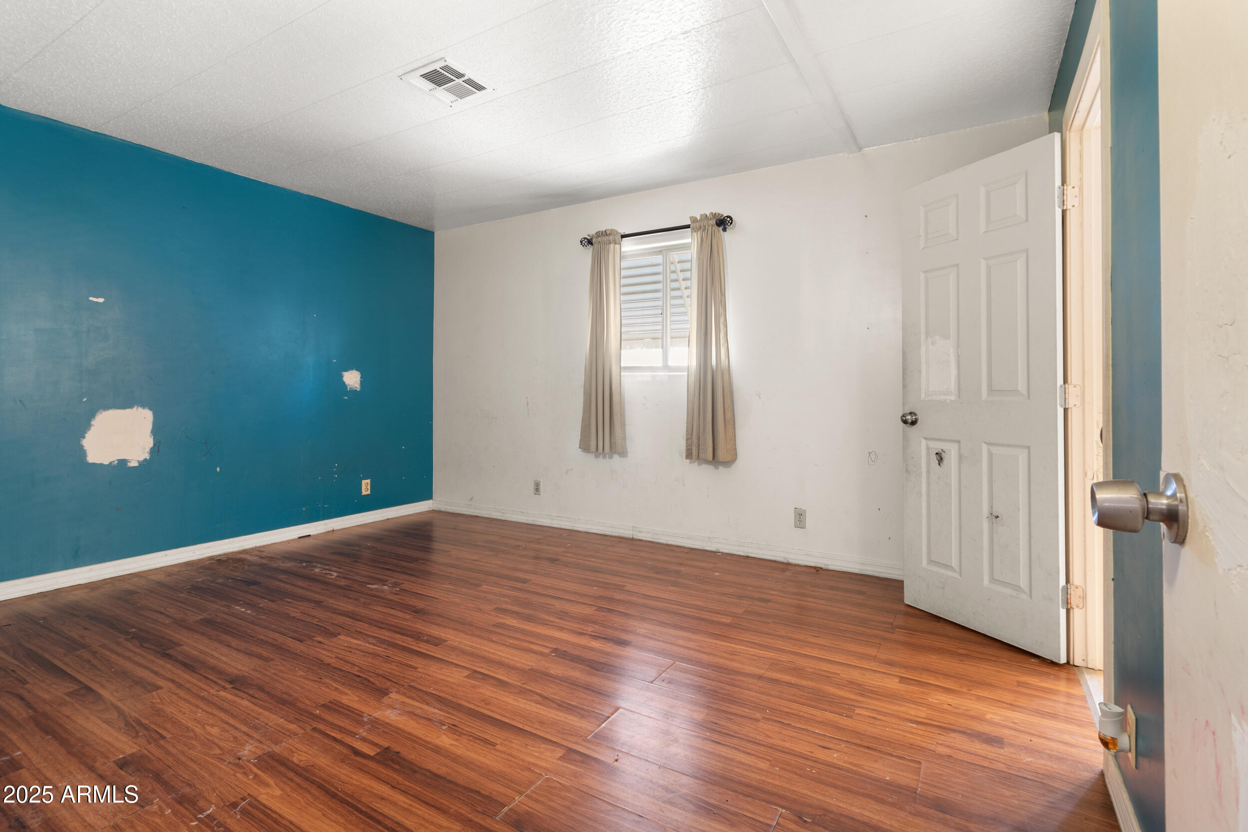 400 West Baseline Road, Unit 179 Tempe, AZ 85283 - Photo 22 of 50 a view of an empty room with wooden floor