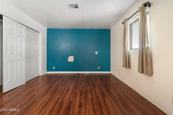a view of a room with wooden floor and windows