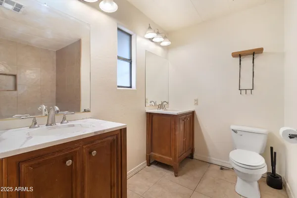 a bathroom with a sink a toilet and mirror