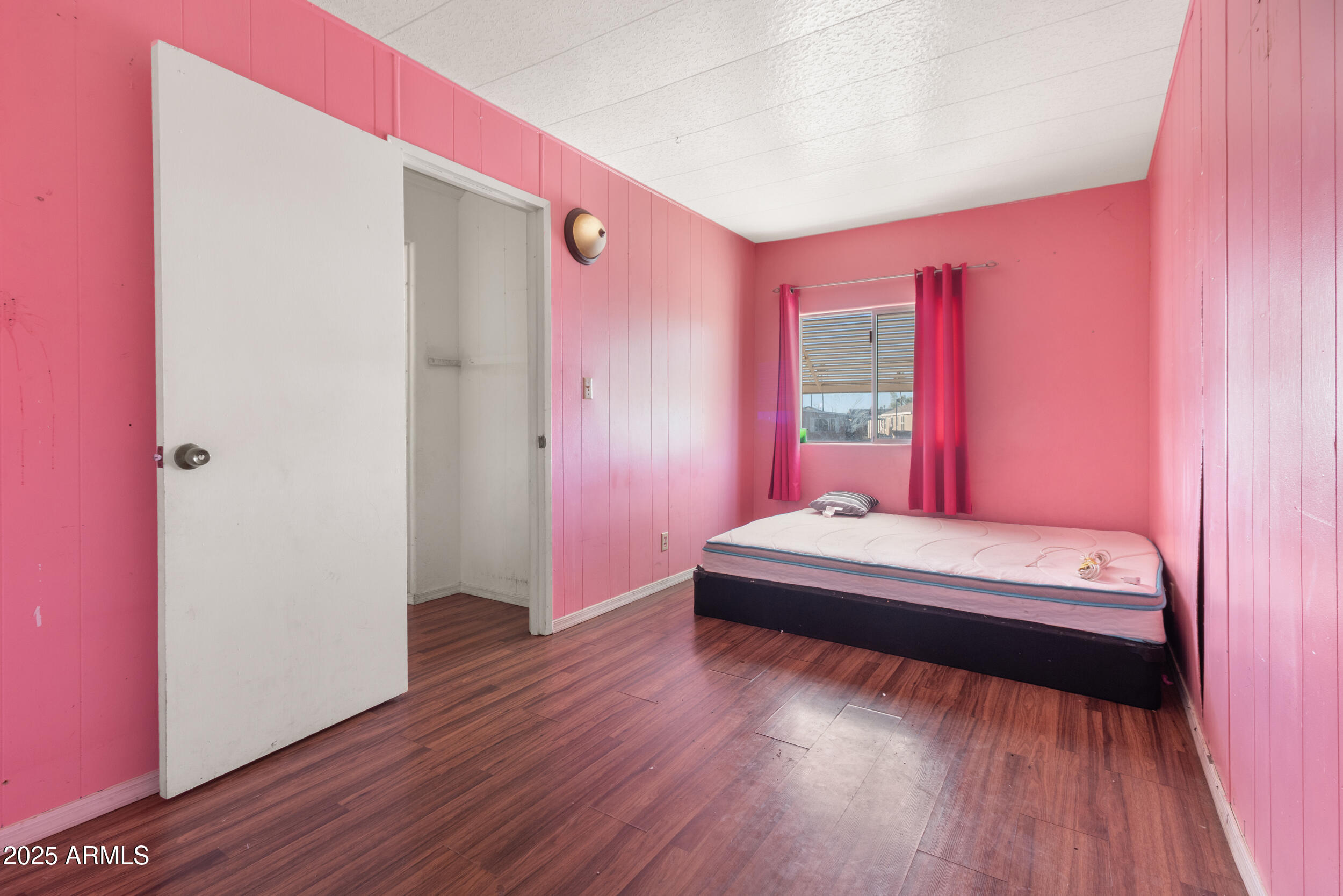 400 West Baseline Road, Unit 179 Tempe, AZ 85283 - Photo 30 of 50 a spacious bedroom with a bed and a wooden floor