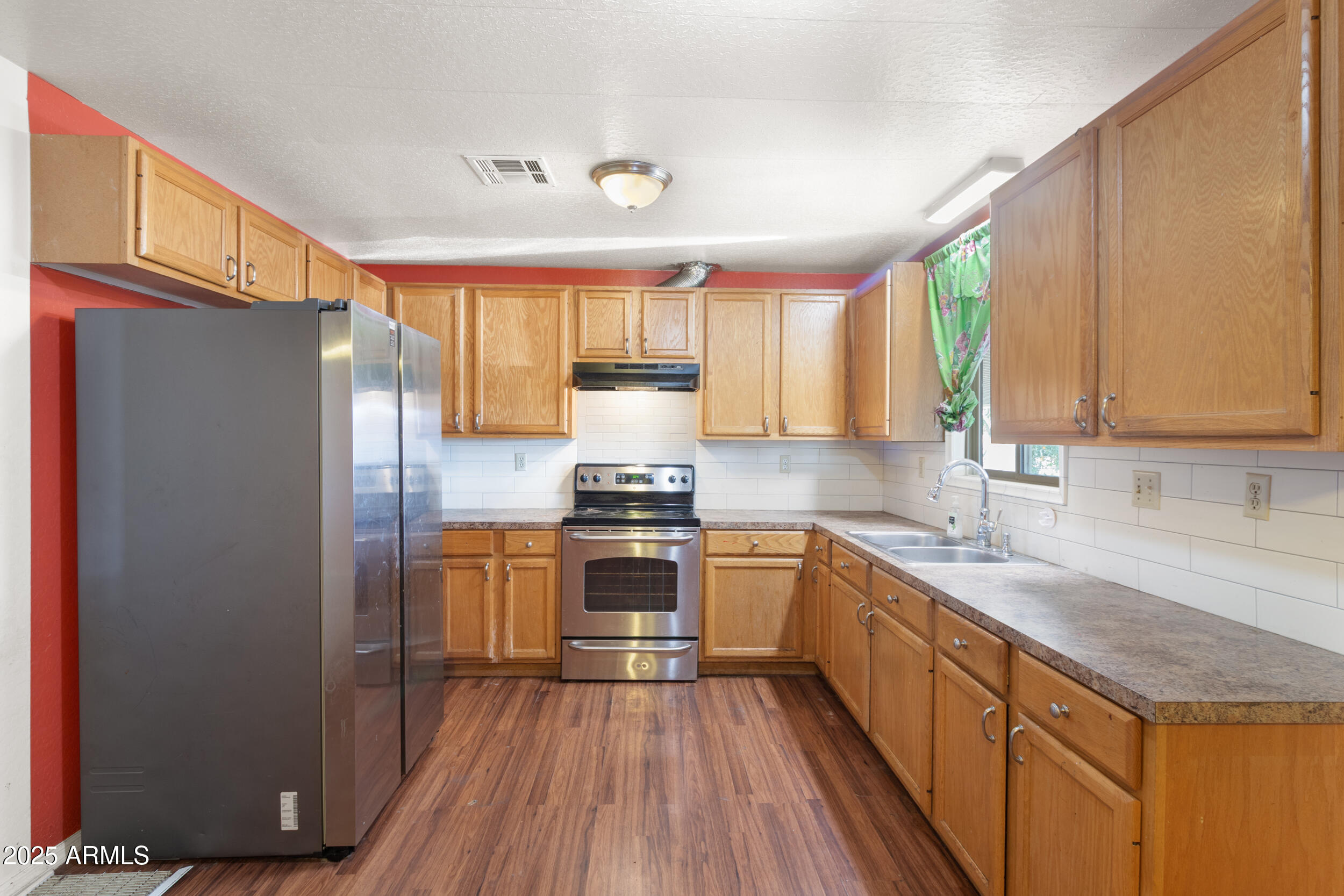 400 West Baseline Road, Unit 179 Tempe, AZ 85283 - Photo 9 of 50 a kitchen with granite countertop wooden floors stainless steel appliances a sink and a window