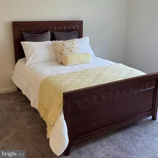 a bedroom with a bed and lamp