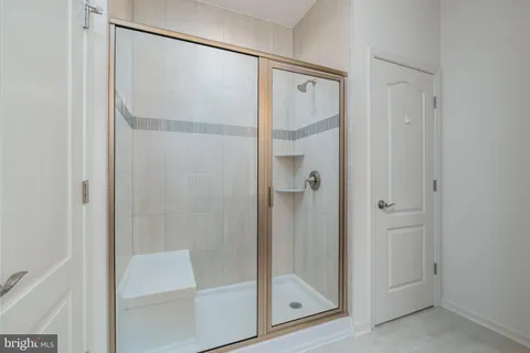 a bathroom with a glass shower door