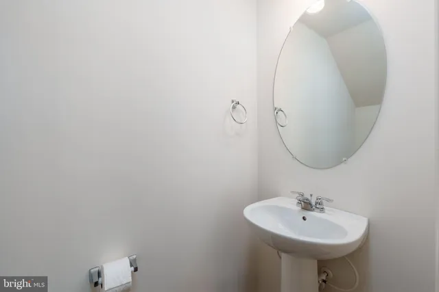 a bathroom with a sink a mirror and a toilet