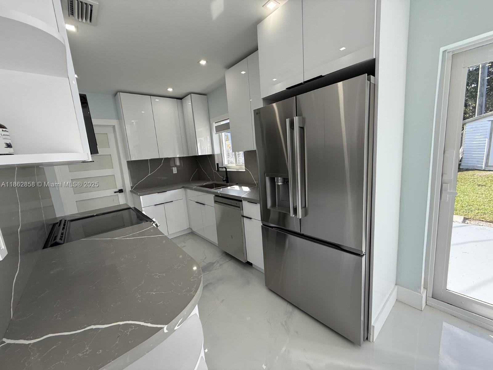 11805 Southwest 185th Street Miami, FL 33177 - Photo 14 of 28 a kitchen with stainless steel appliances granite countertop a refrigerator a sink and a stove