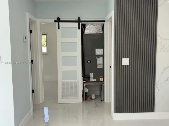 a view of an empty room with a ceiling fan