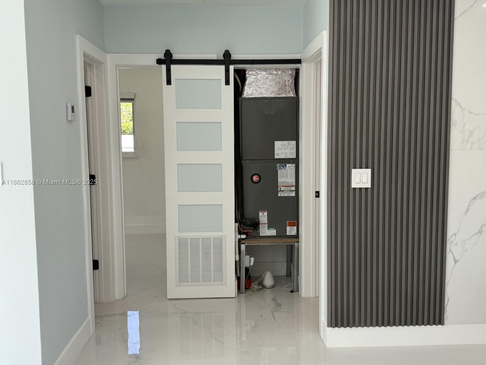 11805 Southwest 185th Street Miami, FL 33177 - Photo 16 of 28 a view of a hallway with wooden shelves