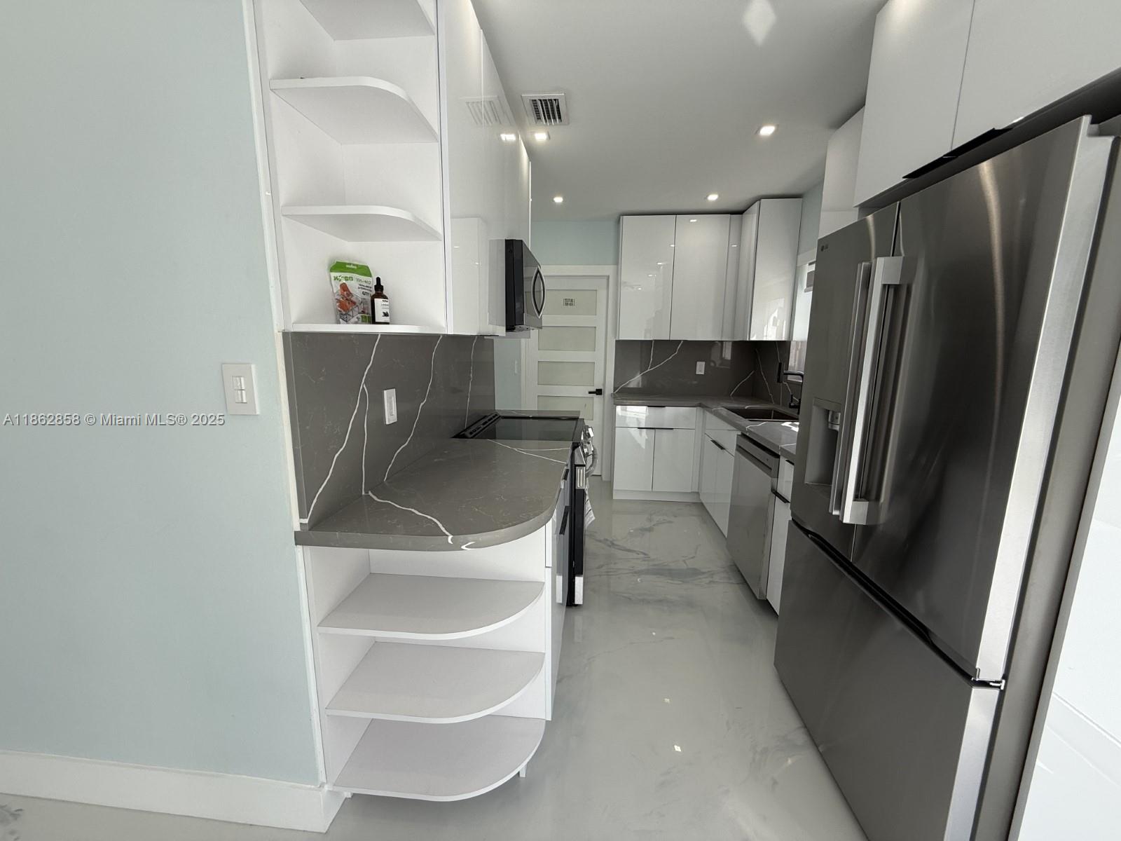 11805 Southwest 185th Street Miami, FL 33177 - Photo 17 of 28 a kitchen with kitchen island a counter top space cabinets and stainless steel appliances