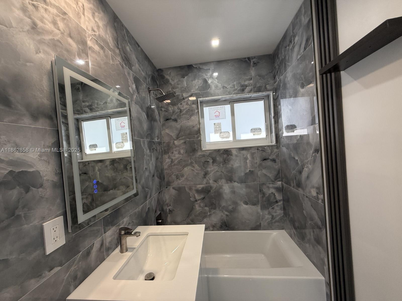 11805 Southwest 185th Street Miami, FL 33177 - Photo 23 of 28 a bathroom with a bathtub and shower