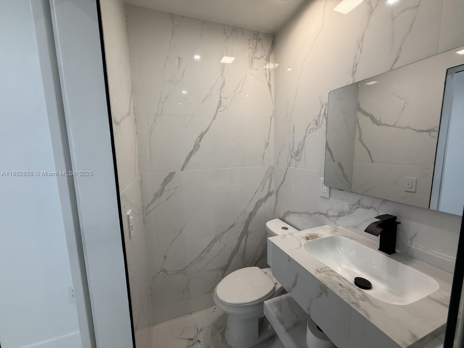 11805 Southwest 185th Street Miami, FL 33177 - Photo 24 of 28 a bathroom with a sink toilet and shower