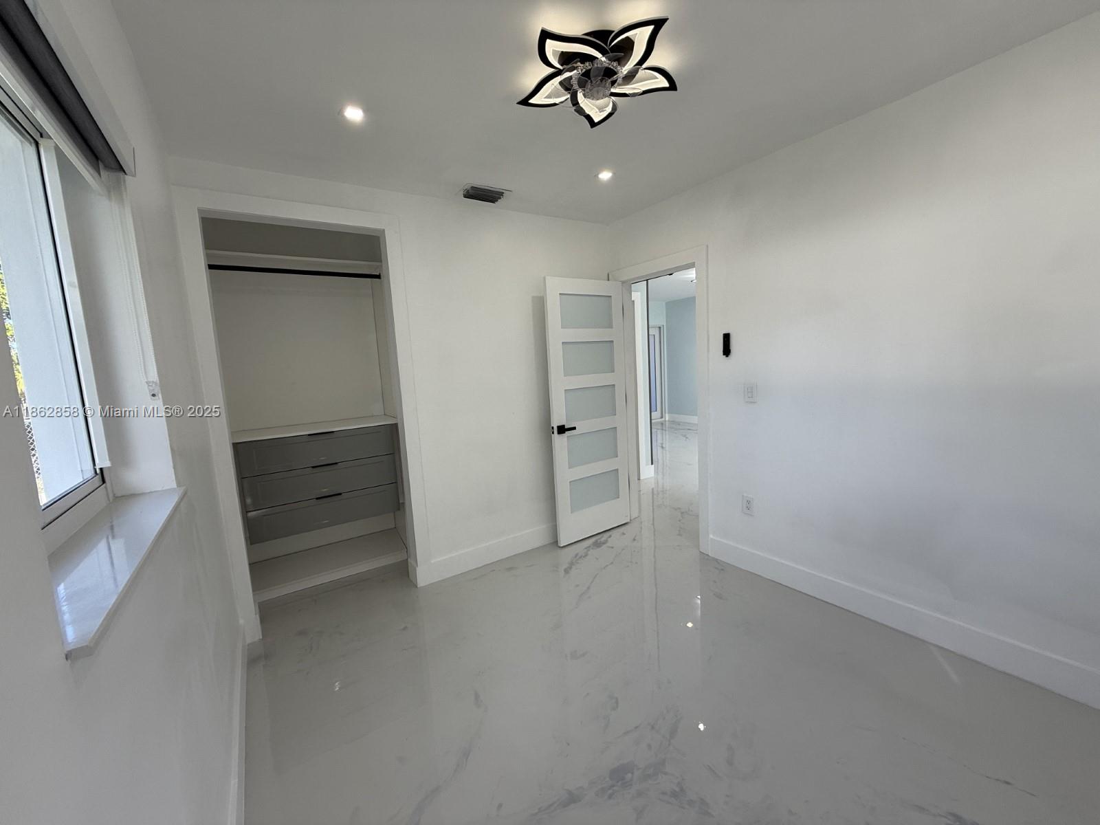 11805 Southwest 185th Street Miami, FL 33177 - Photo 25 of 28 en empty room with closet and window