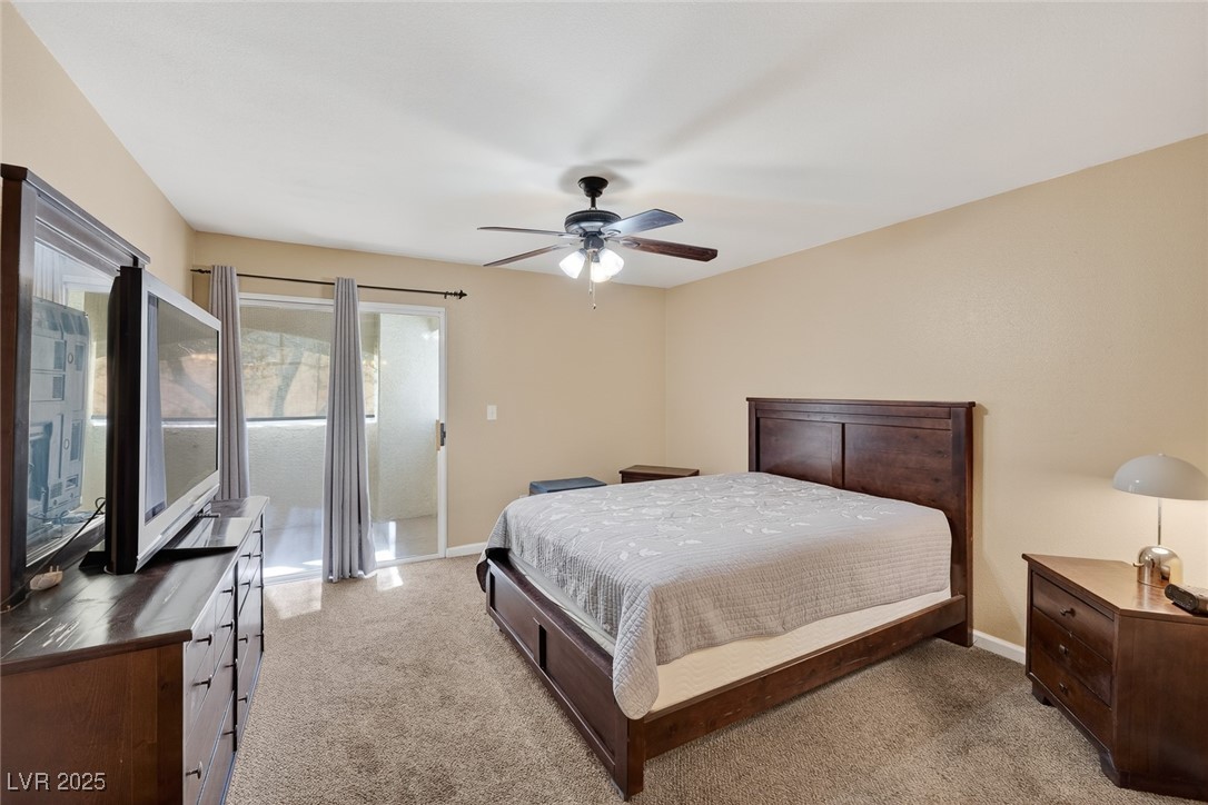 698 South Racetrack Road, Unit 1222 Henderson, NV 89015 - Photo 15 of 31 Bedroom with light carpet, access to exterior, and ceiling fan