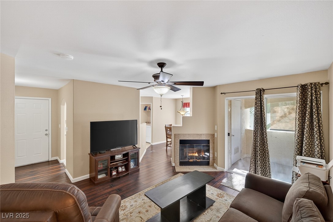 698 South Racetrack Road, Unit 1222 Henderson, NV 89015 - Photo 5 of 31 Living room with hardwood / wood-style flooring, a glass covered fireplace, and a ceiling fan
