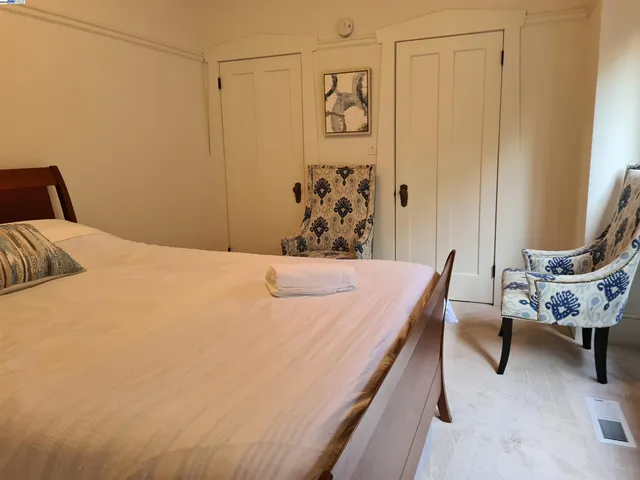 a bedroom with a bed and a chair